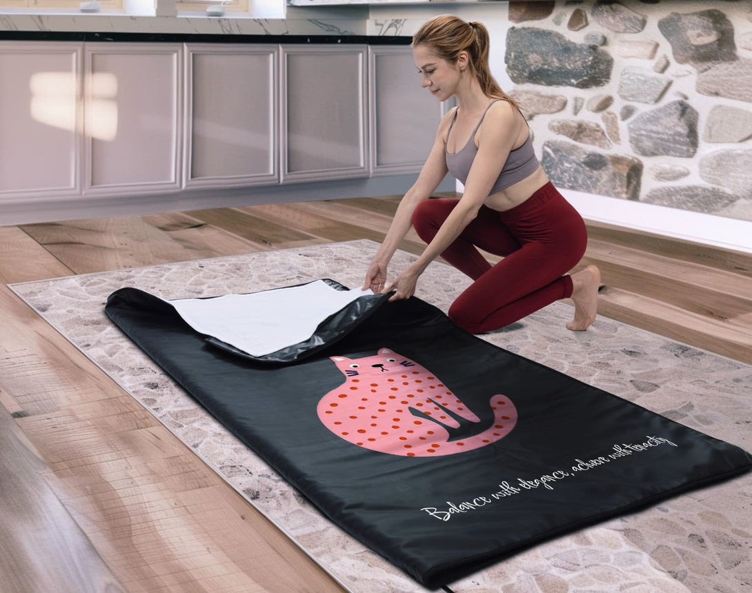 Enercozy 'Gentle Feline Grace' Infrared Sauna Blanket folded and displayed, emphasizing its graceful design and how it helps you maintain balance and determination.